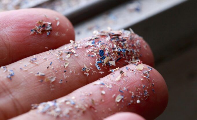ca_microplastic_pollution_hand_istock-1317882487.jpg